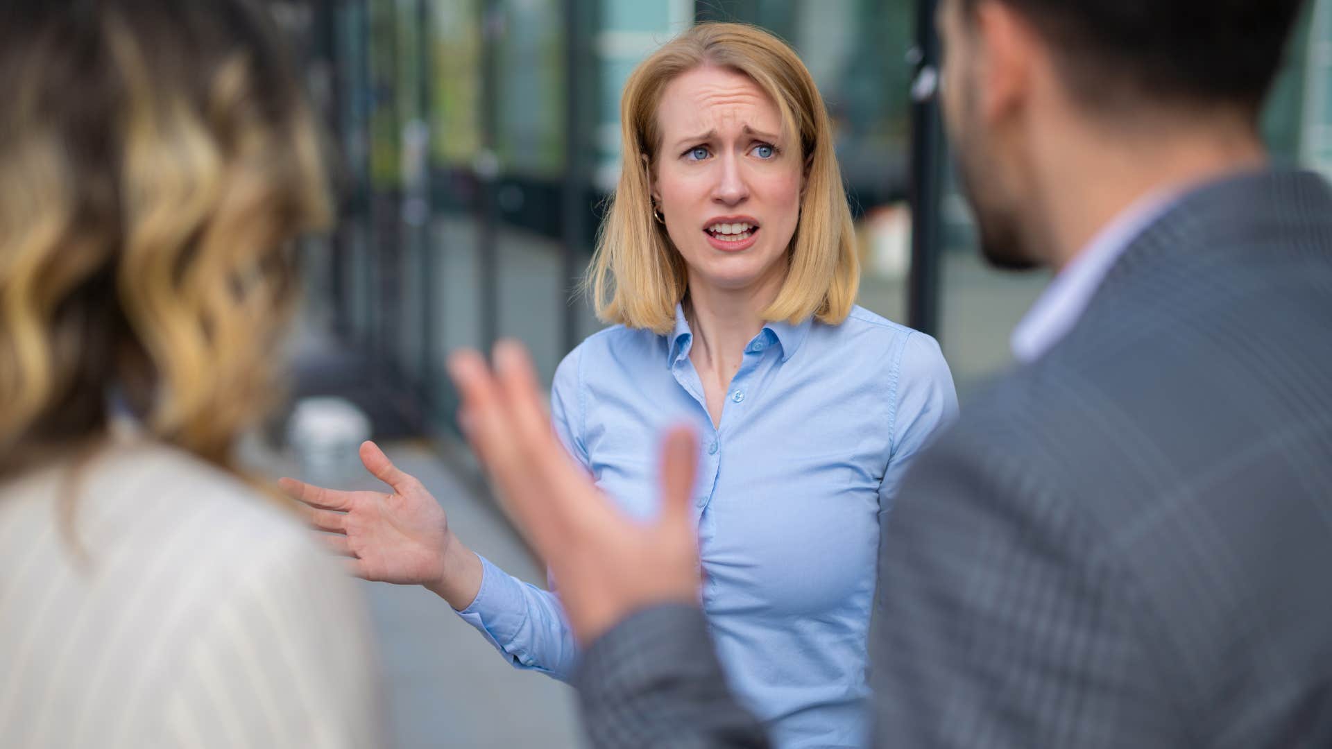annoyed woman willing to discuss something if it doesn't become personal with co-worker