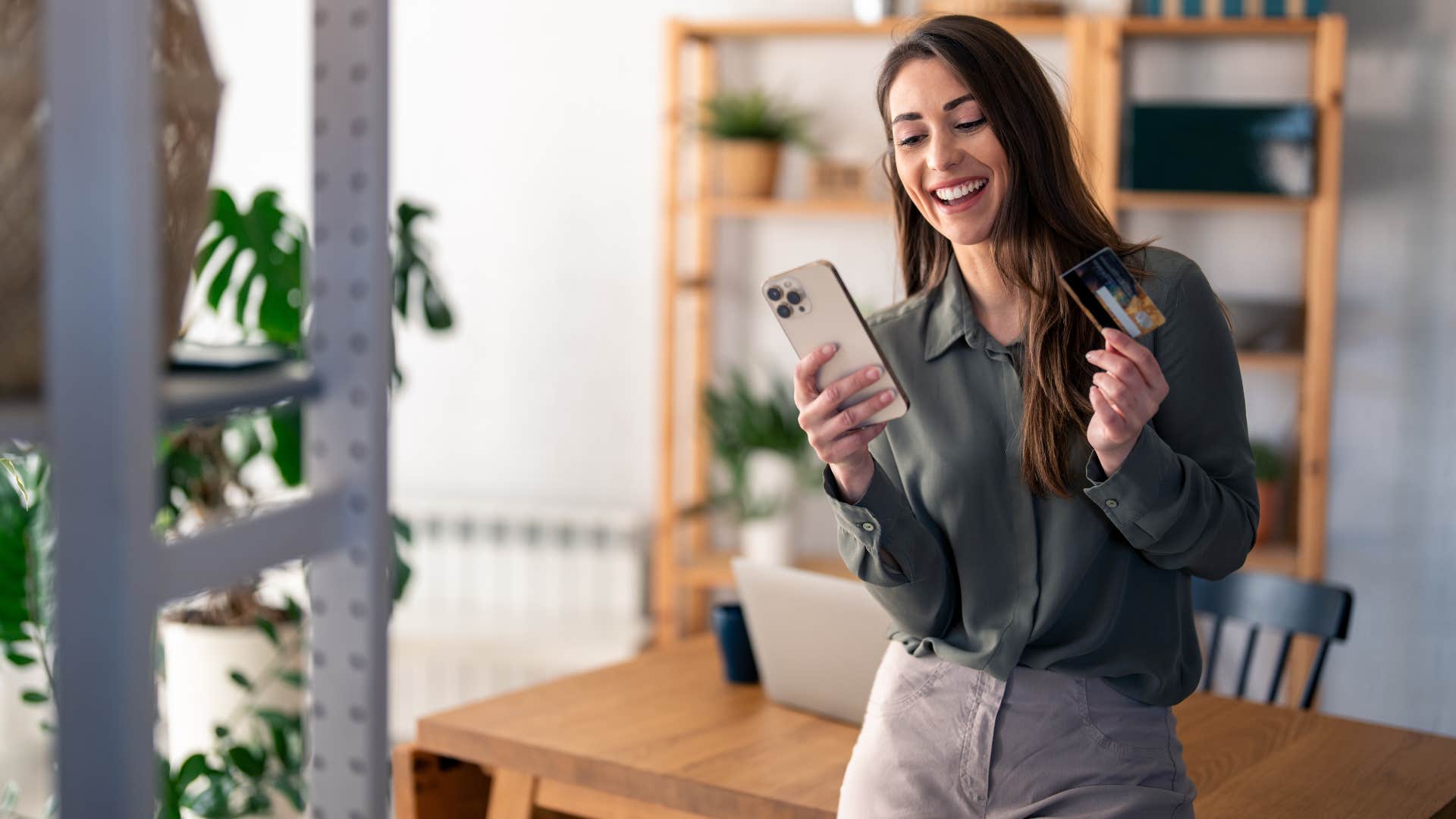 woman shopping on phone telling herself money doesnt buy happiness