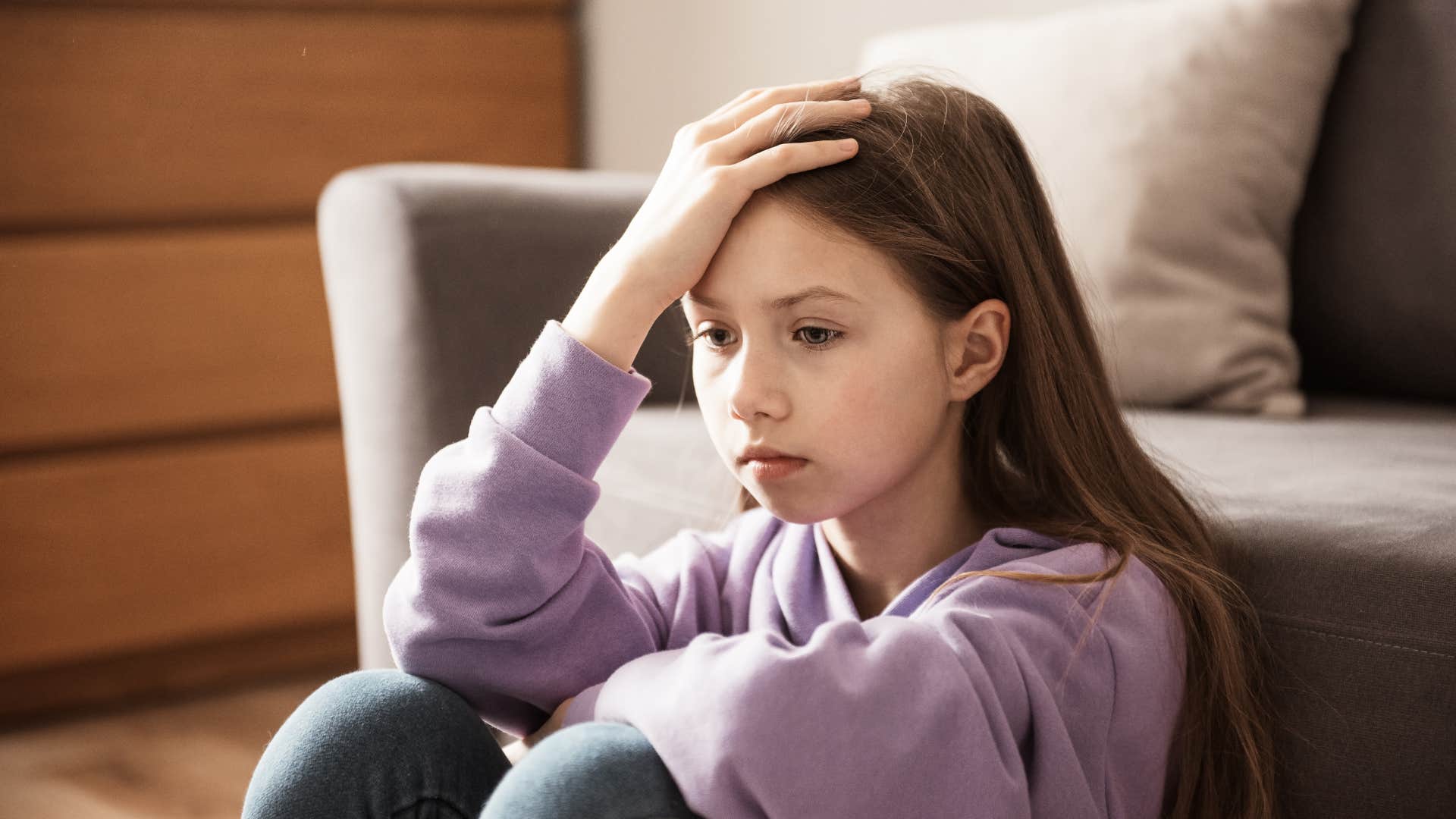 unhappy young girl sitting on the floor wishing she could start over