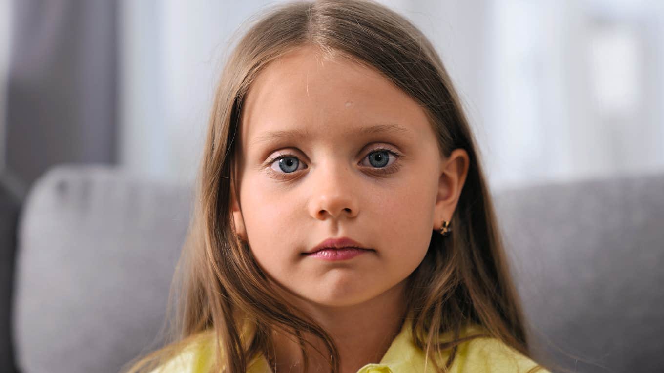 deeply unhappy child looking sad