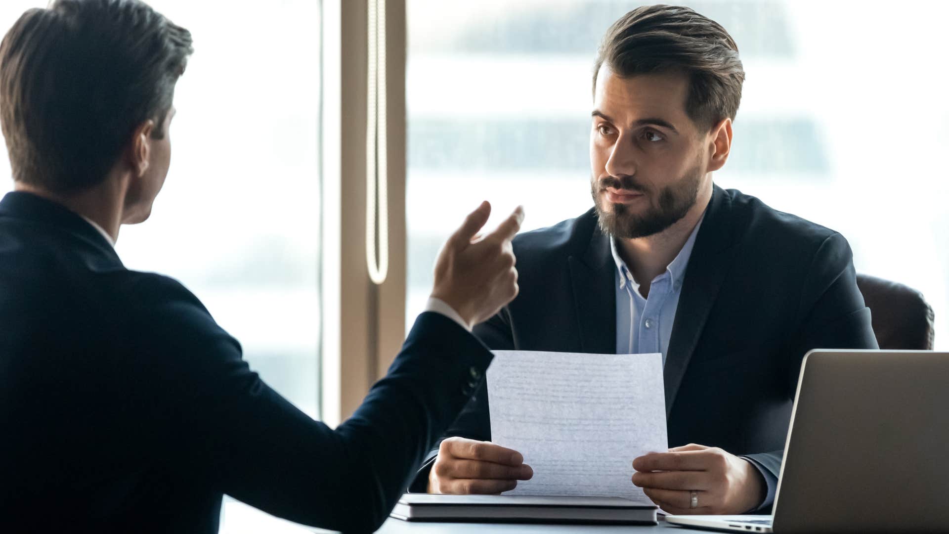 man saying why are you asking so many questions to his co-worker