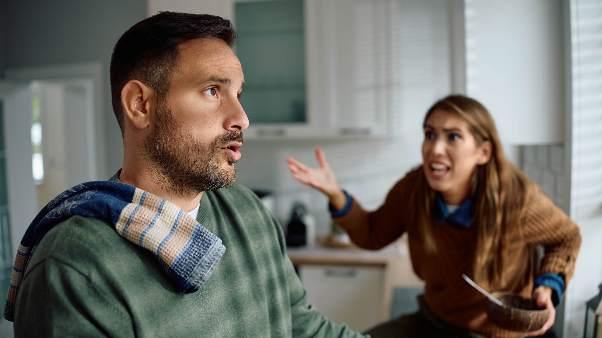 woman in brown shirt complaining to man you're not working hard enough