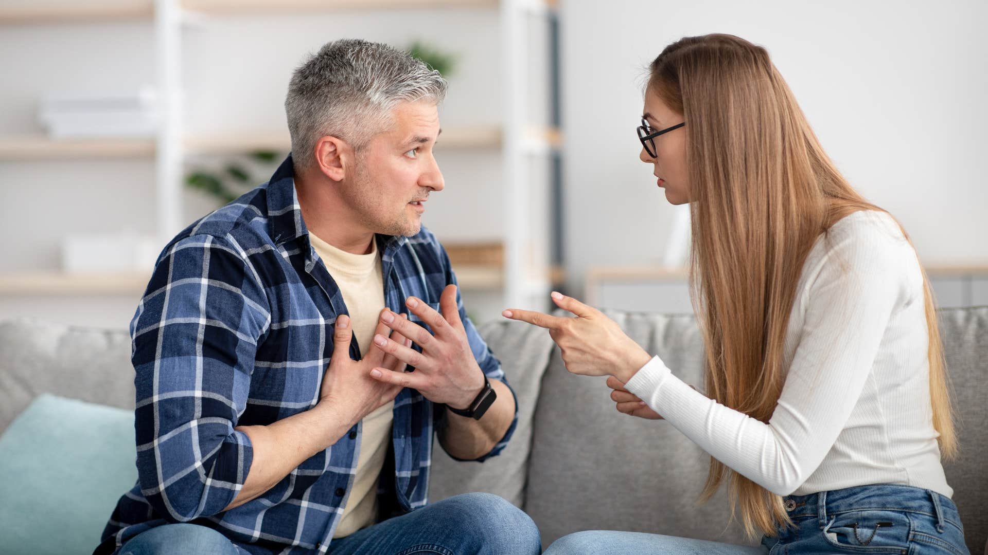 woman telling man he never does anything as man in plaid blue argues back