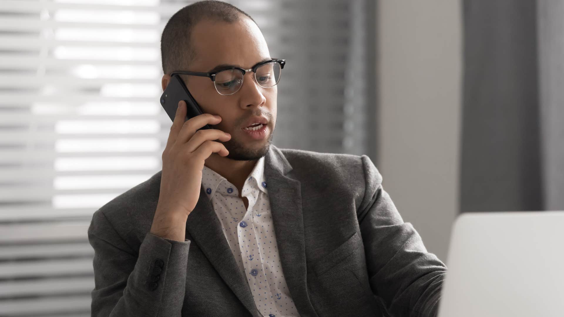 man saying we need you to come in early on the phone to colleague