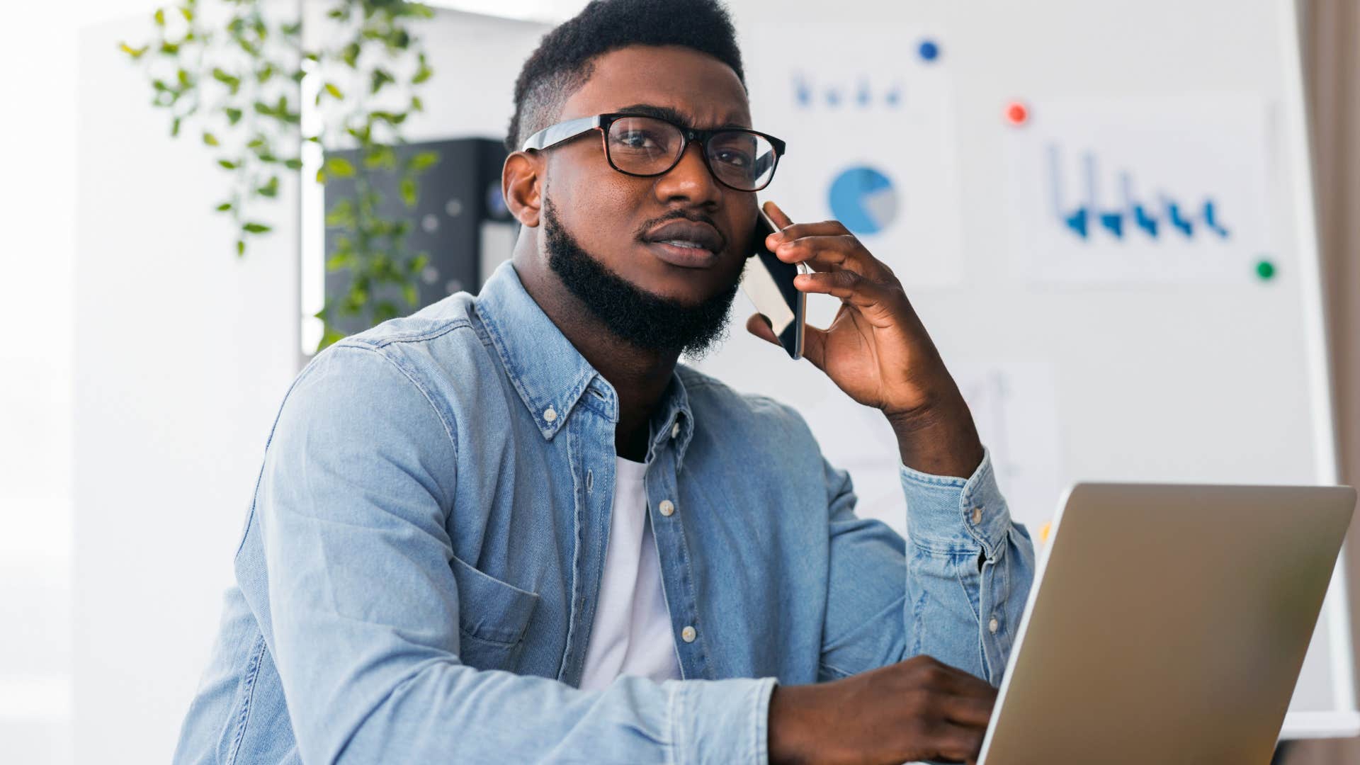 man saying there's no excuses to lazy co-worker on the phone