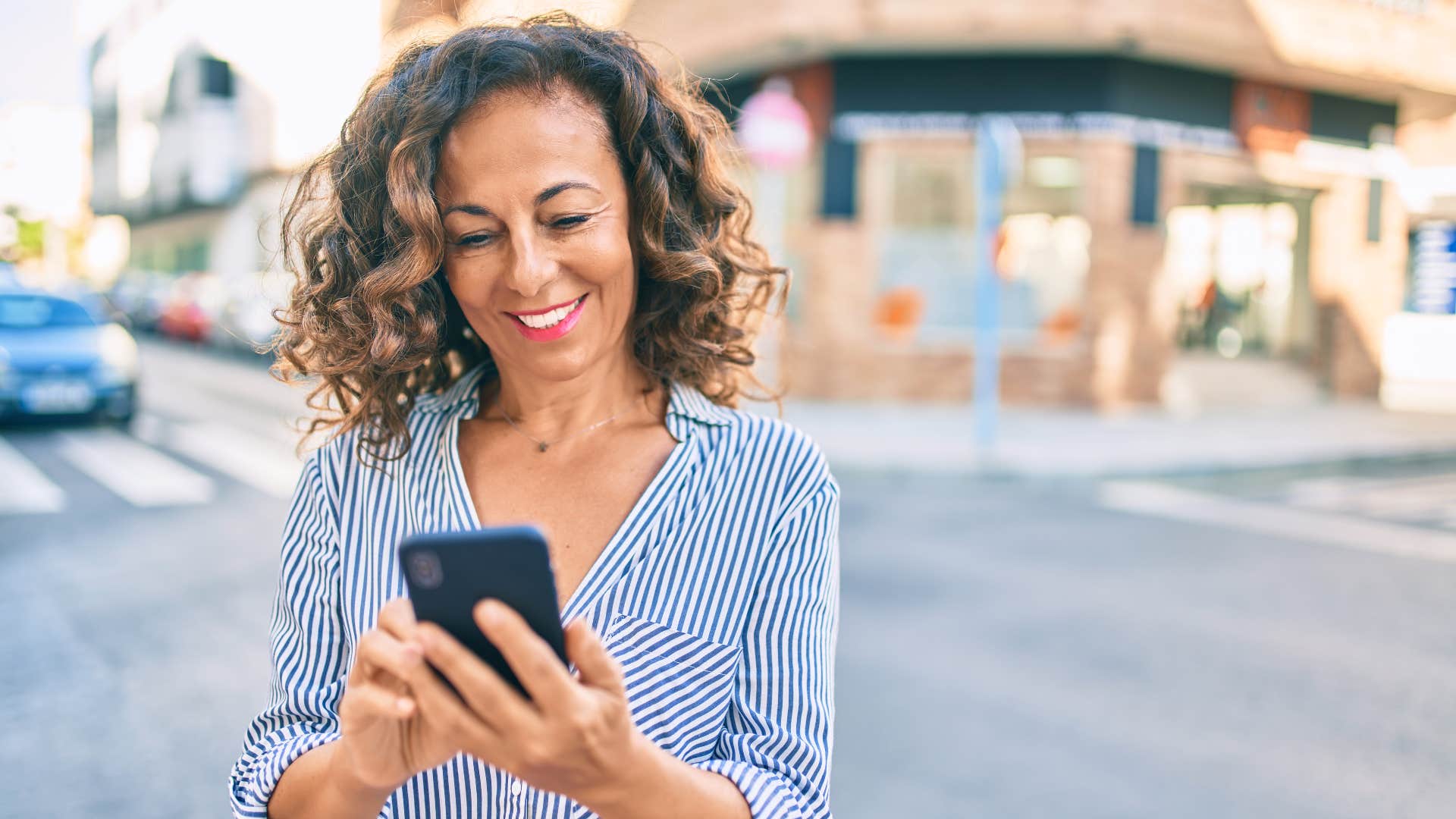 woman in stripped shirt responding immediately to every text message