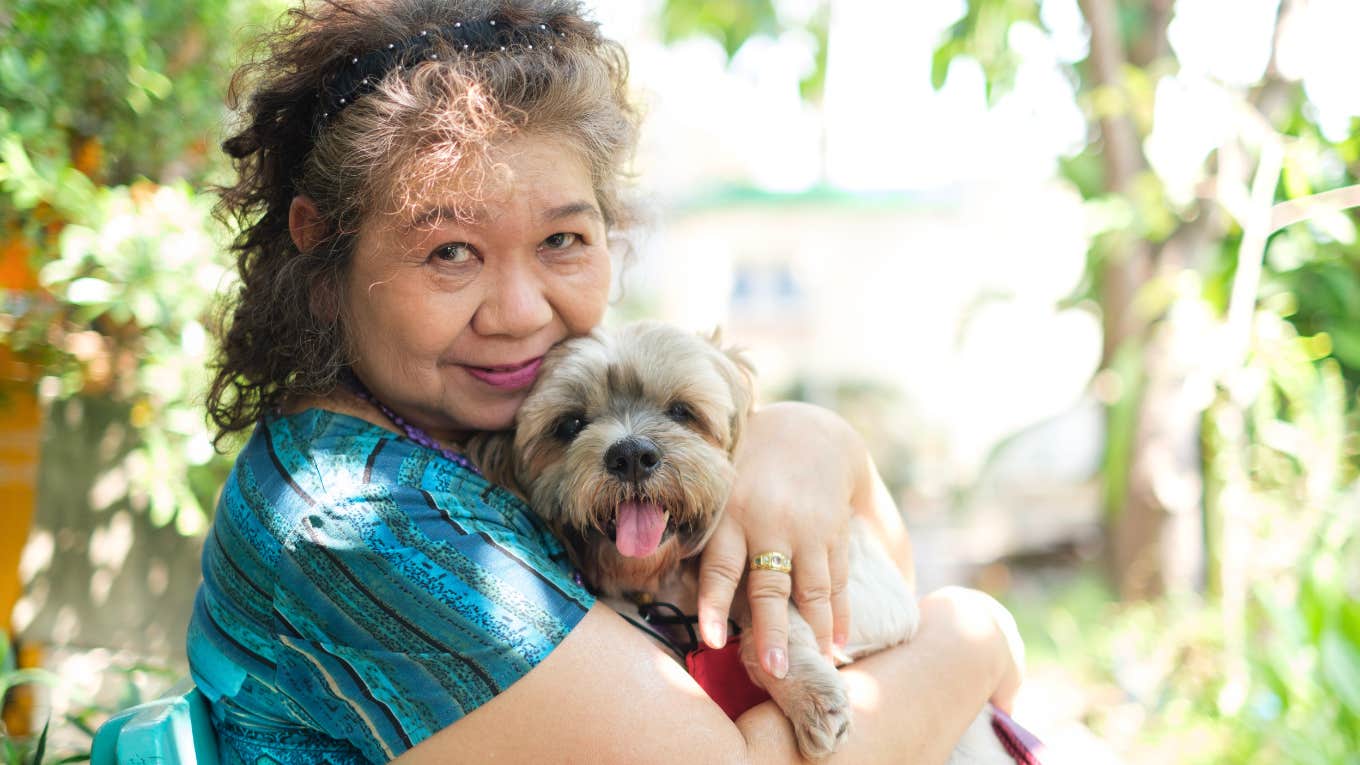 Reasons People Who Would Rather Just Hang Out With Their Dogs As They Get Older Usually Have older woman snuggling her dog outside