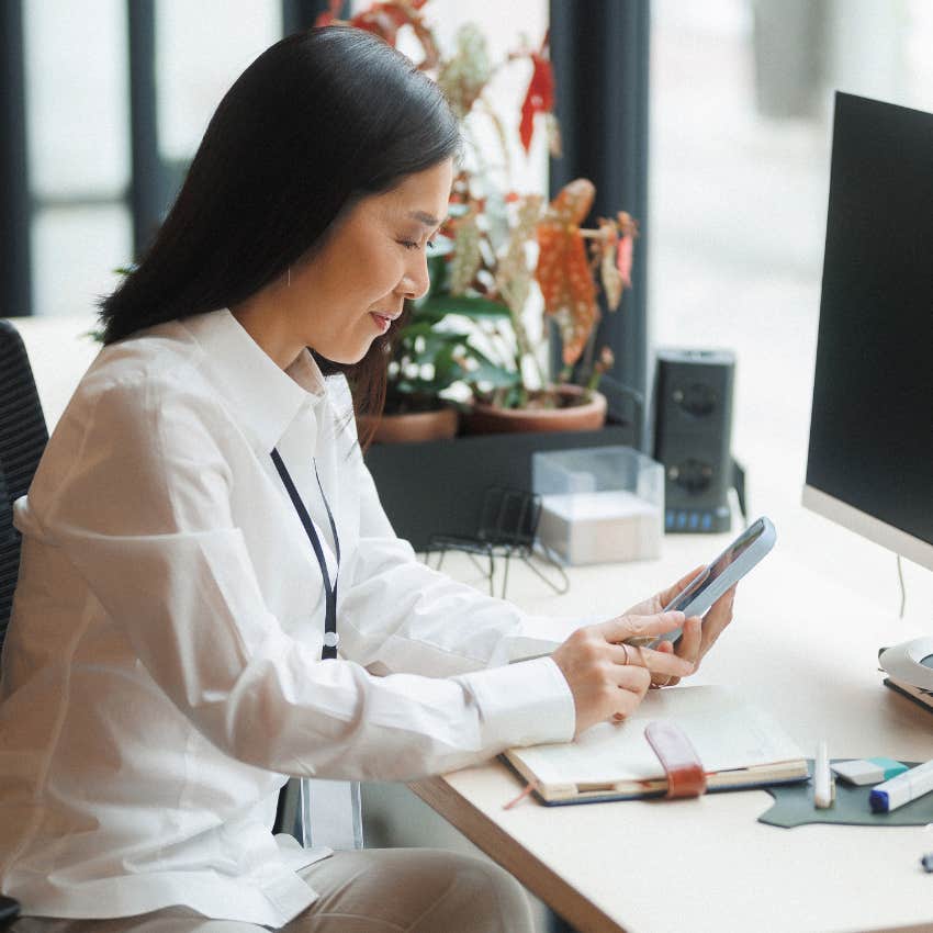 woman checking phone for work communications