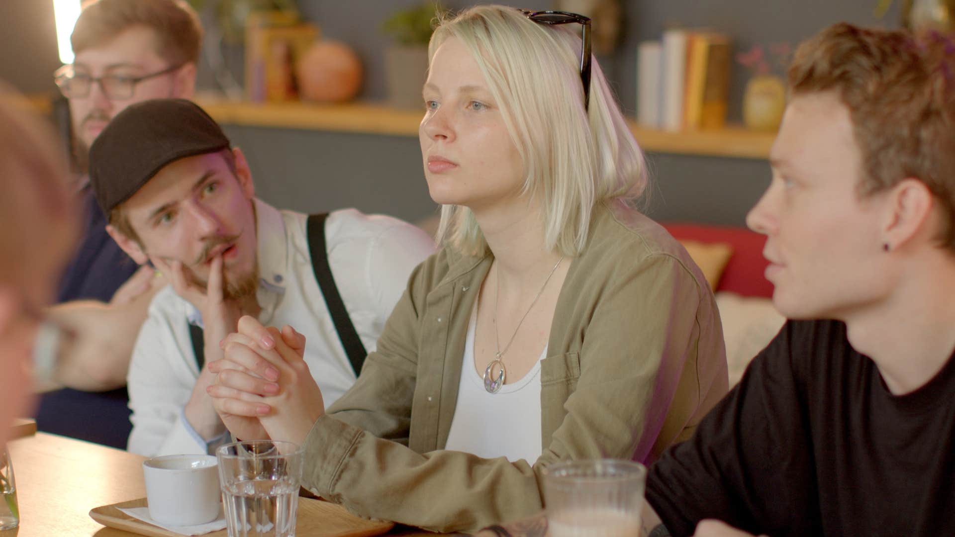 Woman whose appearance has changed sitting between her friends.