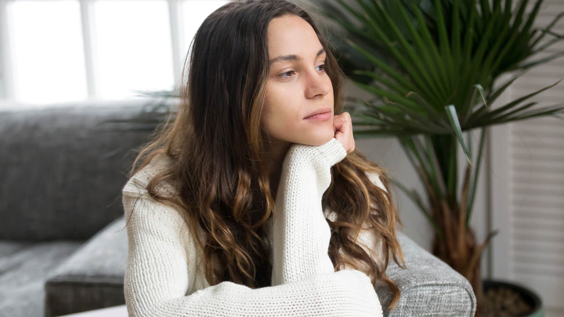Woman who's quieter than normal looking out a window.