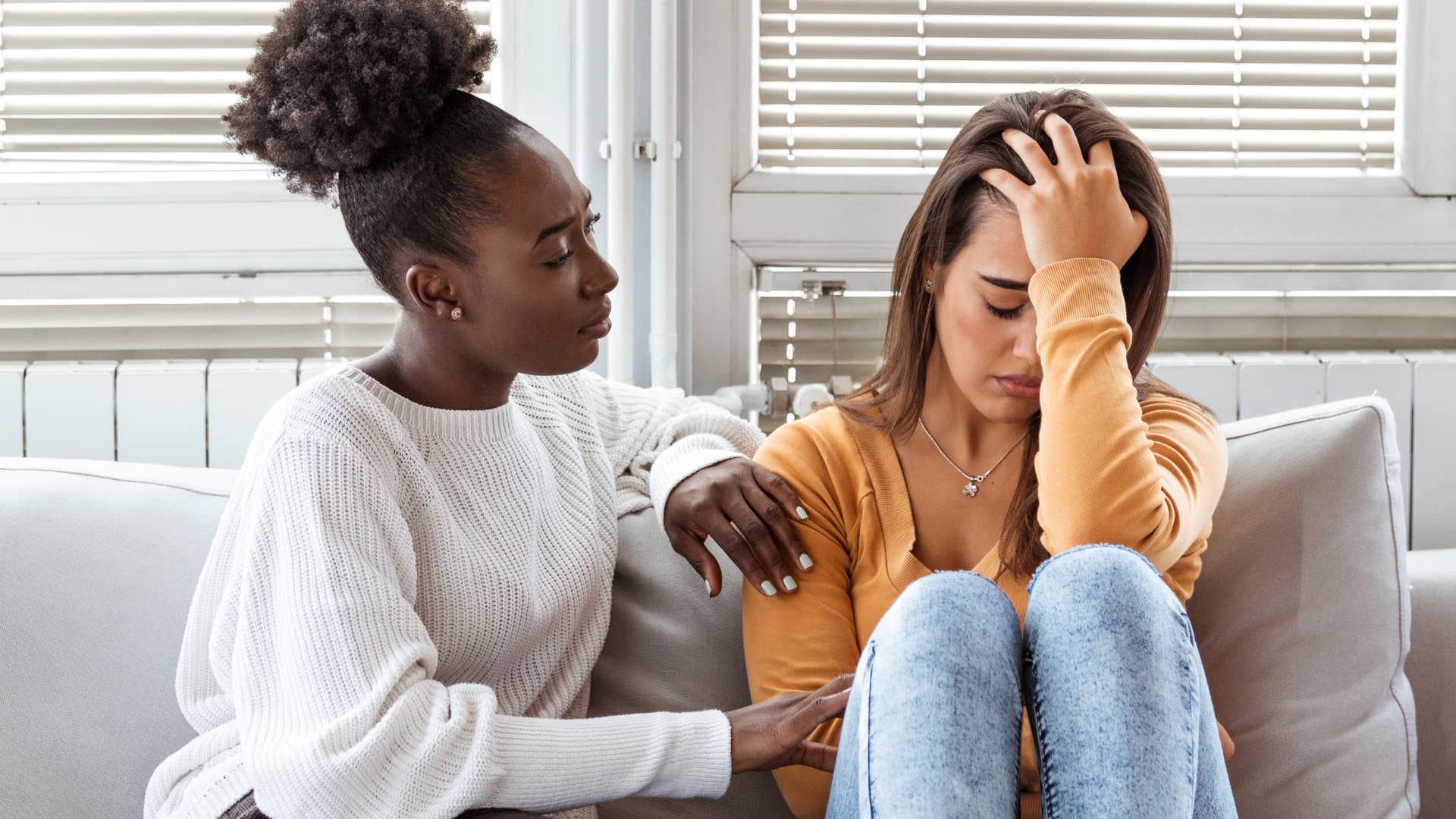 Woman speaking negatively about herself next to a friend.