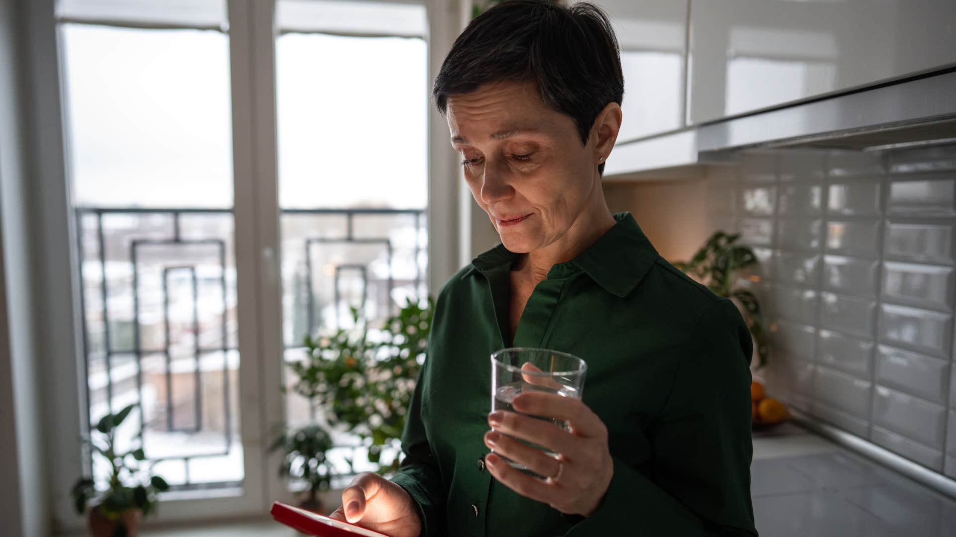 Woman who's stopped reaching out looking at her phone.