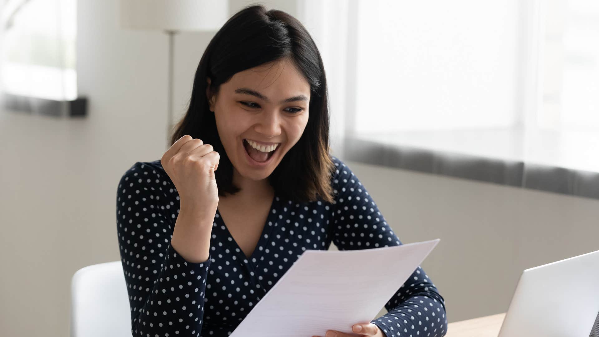 woman cheering after getting refund