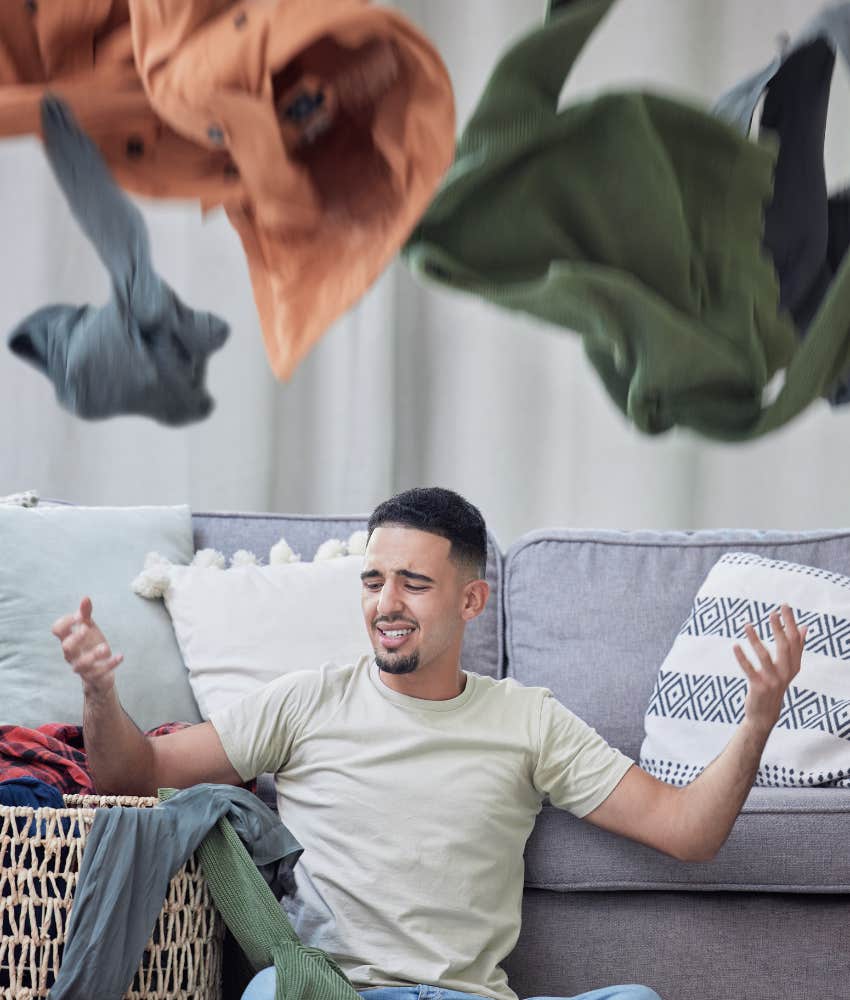 Man who is cleaning channels angry energy into laundry