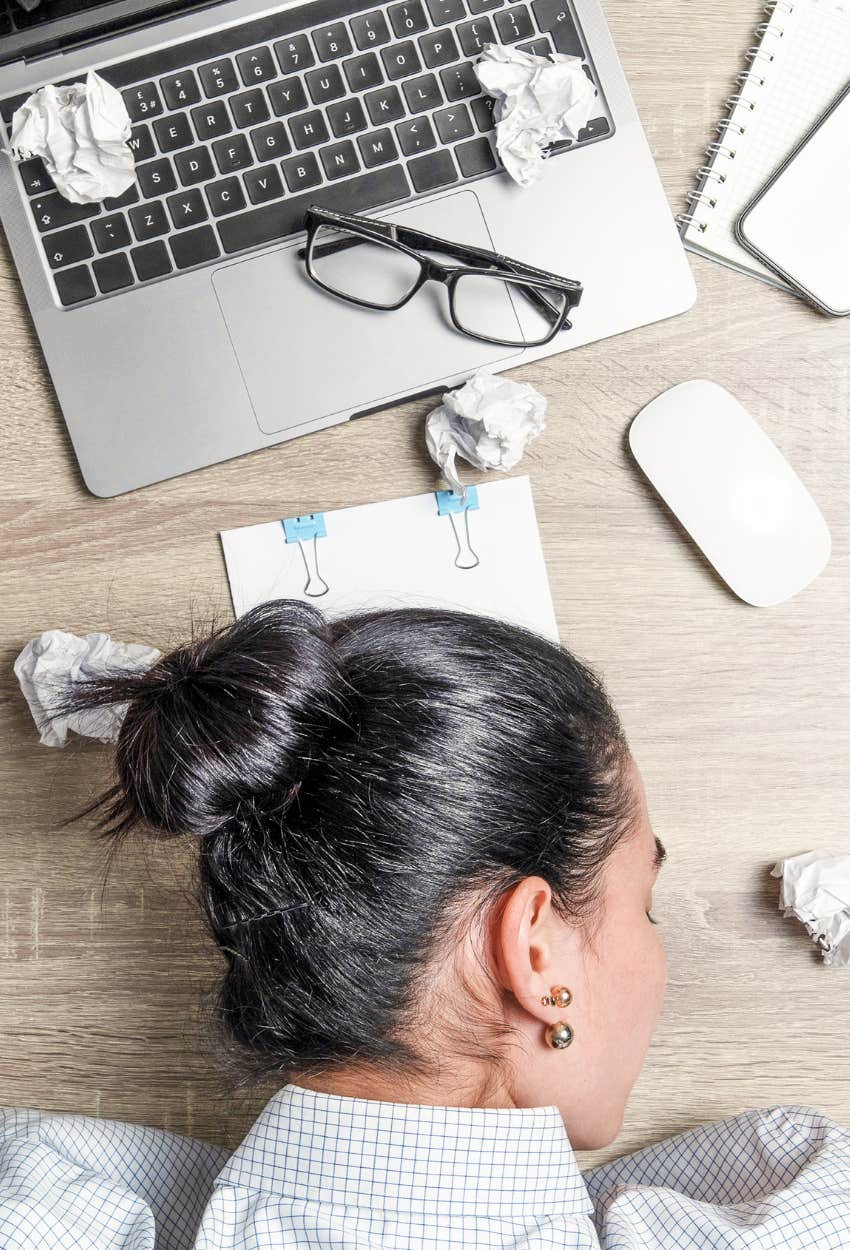 woman with a shifting workload sign of quiet layoffs