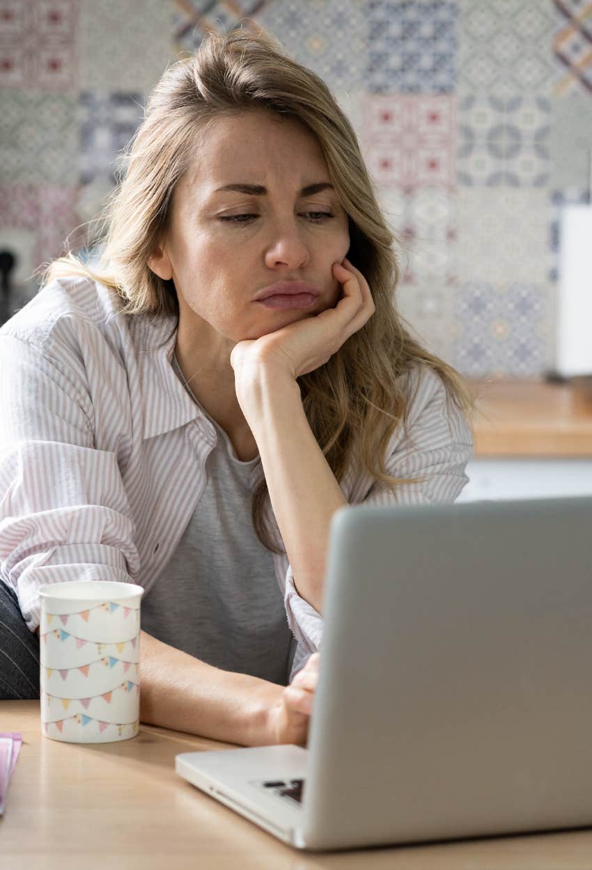 worker reading a vague email from company leadership sign quiet layoff