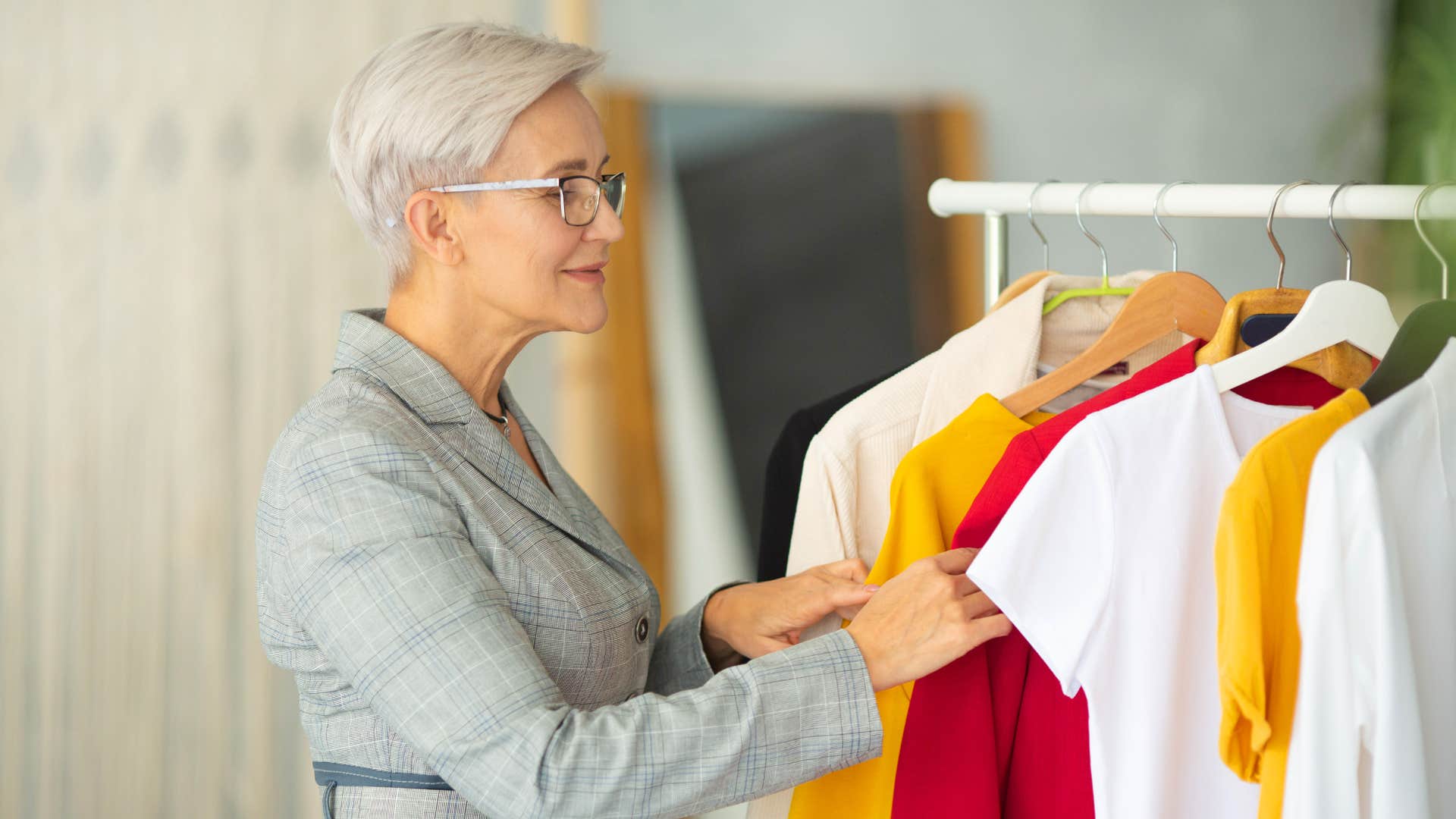 woman decked out in nice suit as she looks through clothes