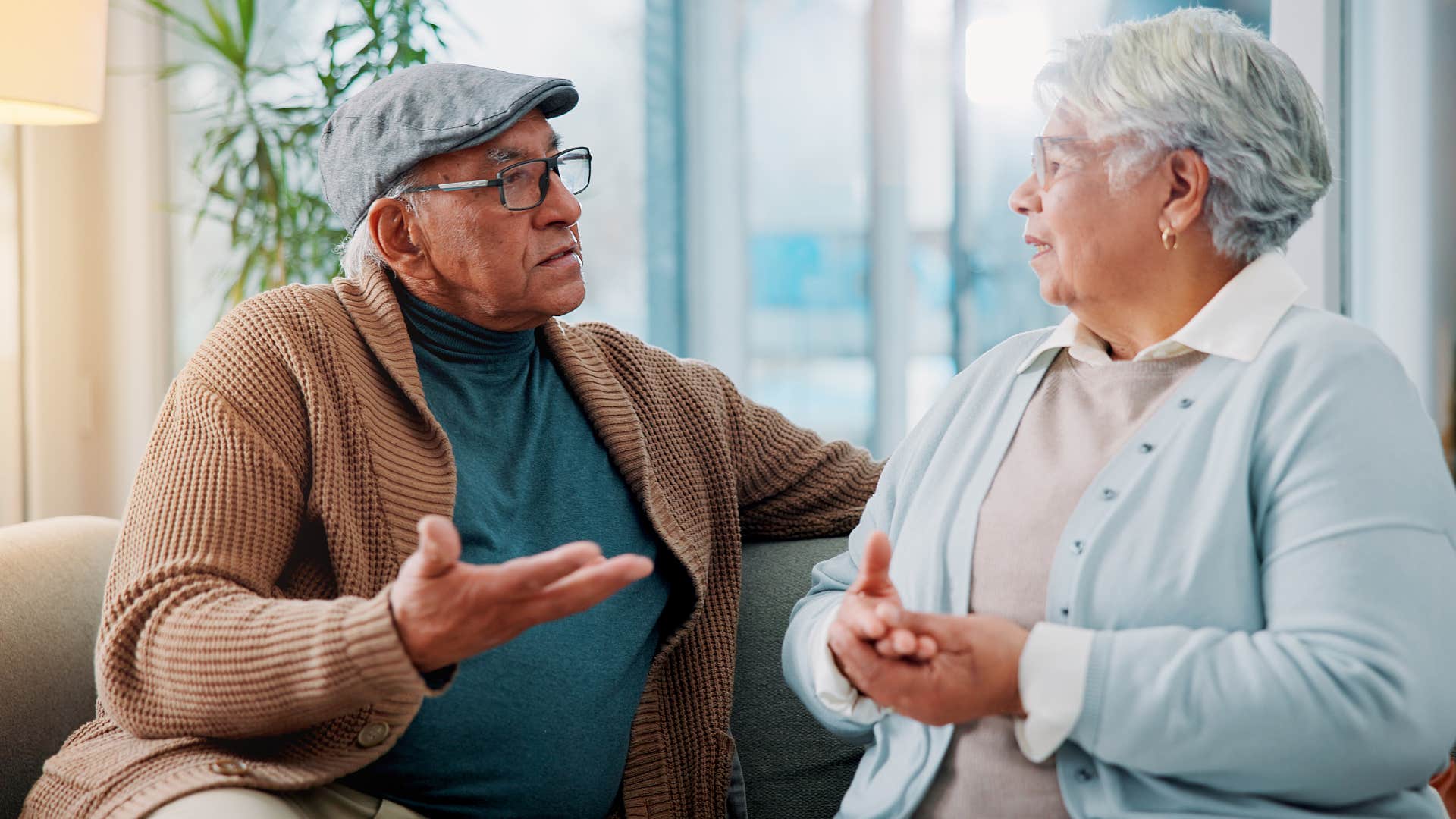 man in blue shirt asking woman in lighter blue cardigan what's your bag