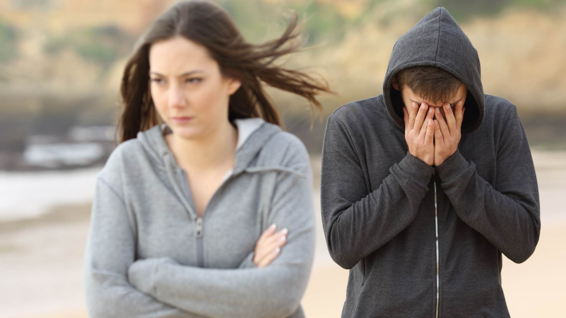 woman walking away from man on a beach