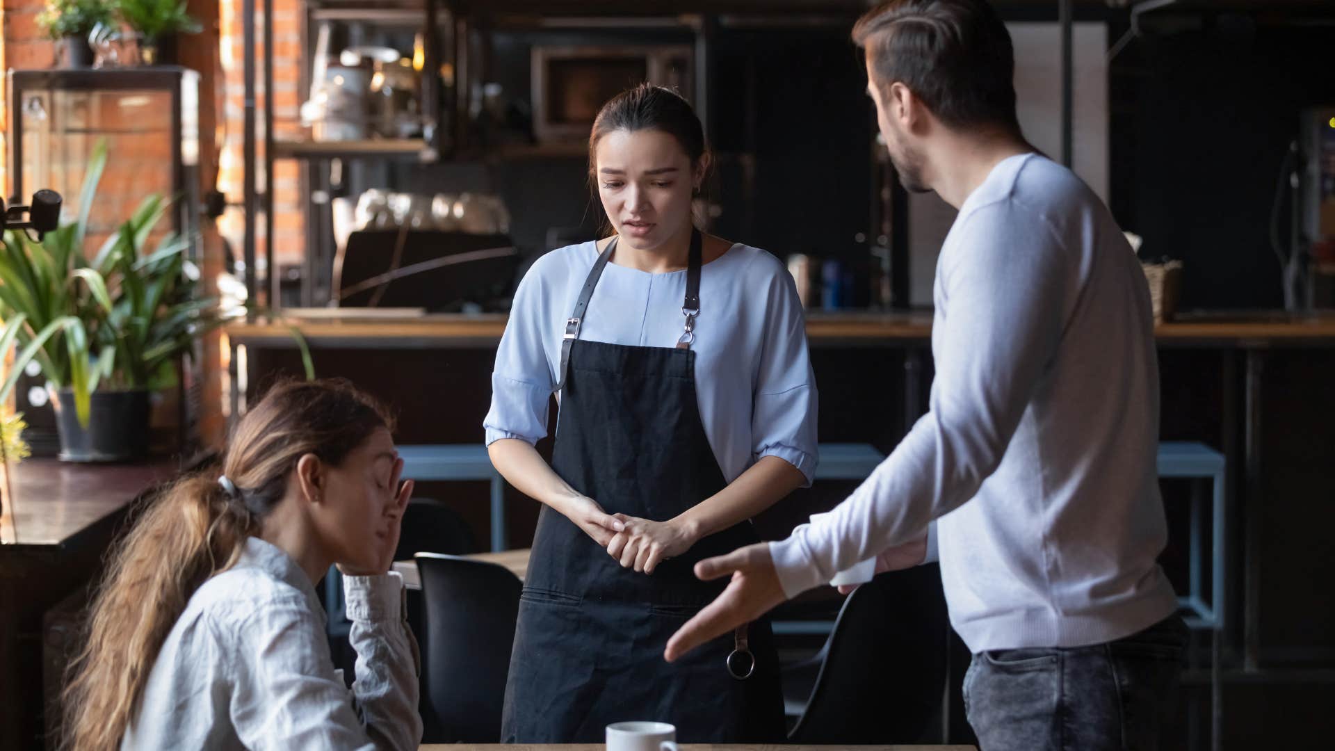 man treating service worker poorly in front of his wife