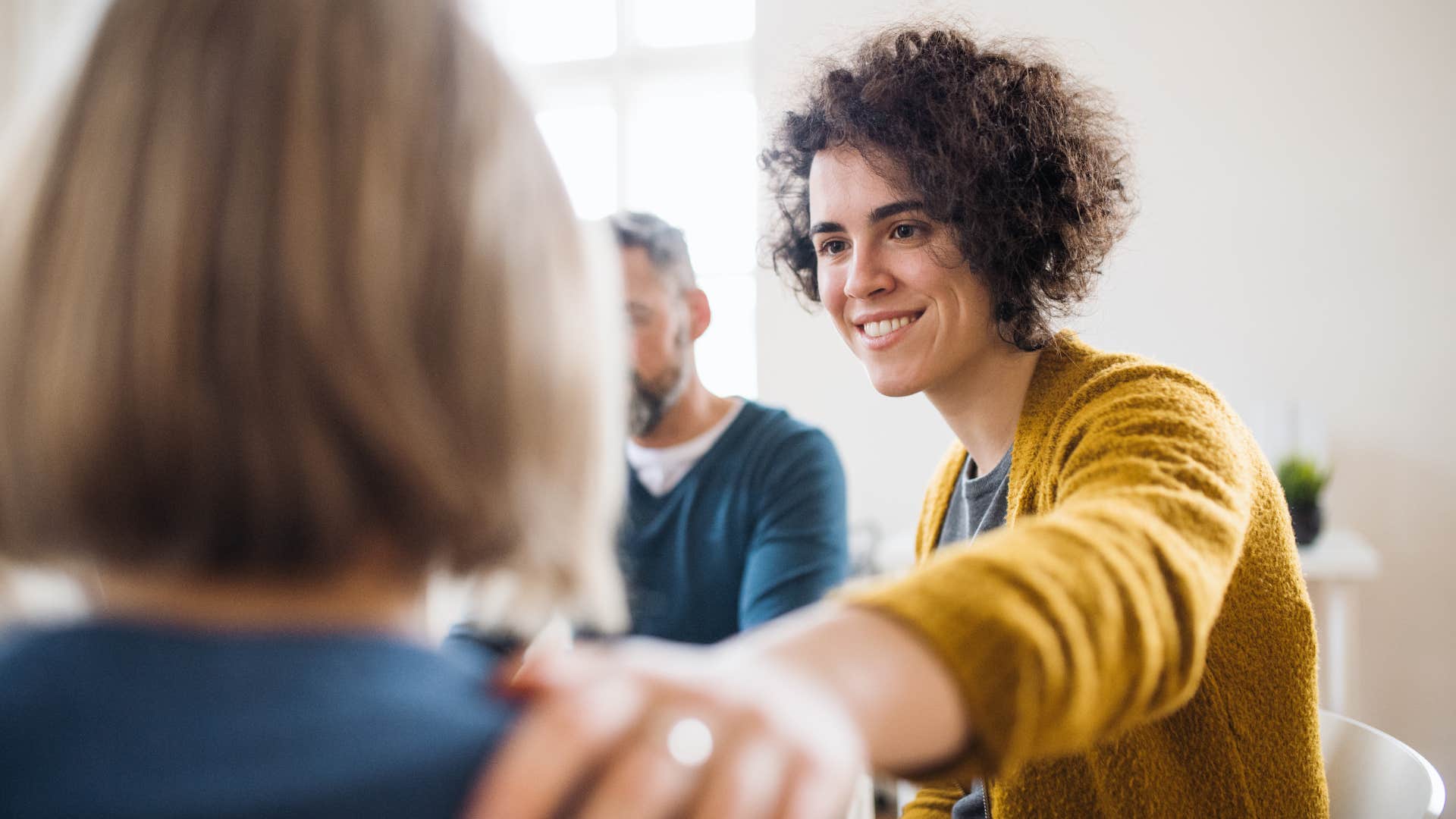 woman in yellow touches woman's shoulders as she tells her to do the right thing even when nobody is watching