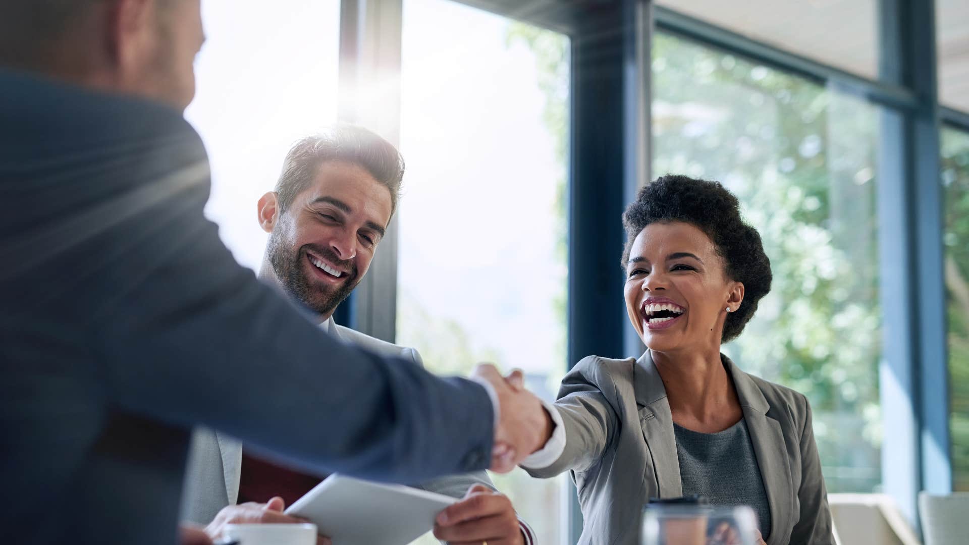 woman treating everyone with respect as she shakes hands with man