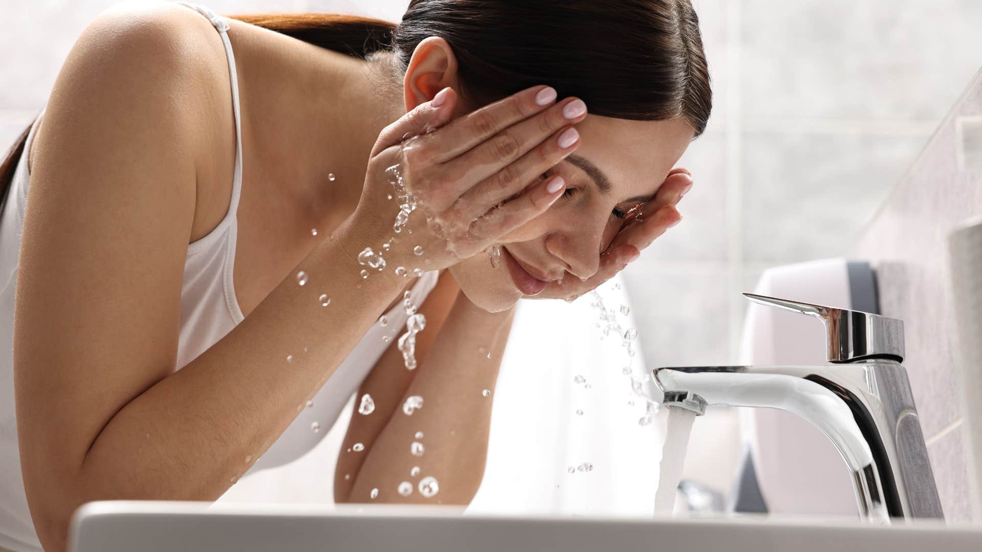 woman washing her face