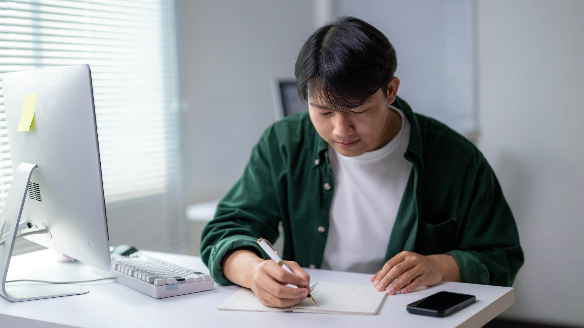 man writing down goal for tomorrow