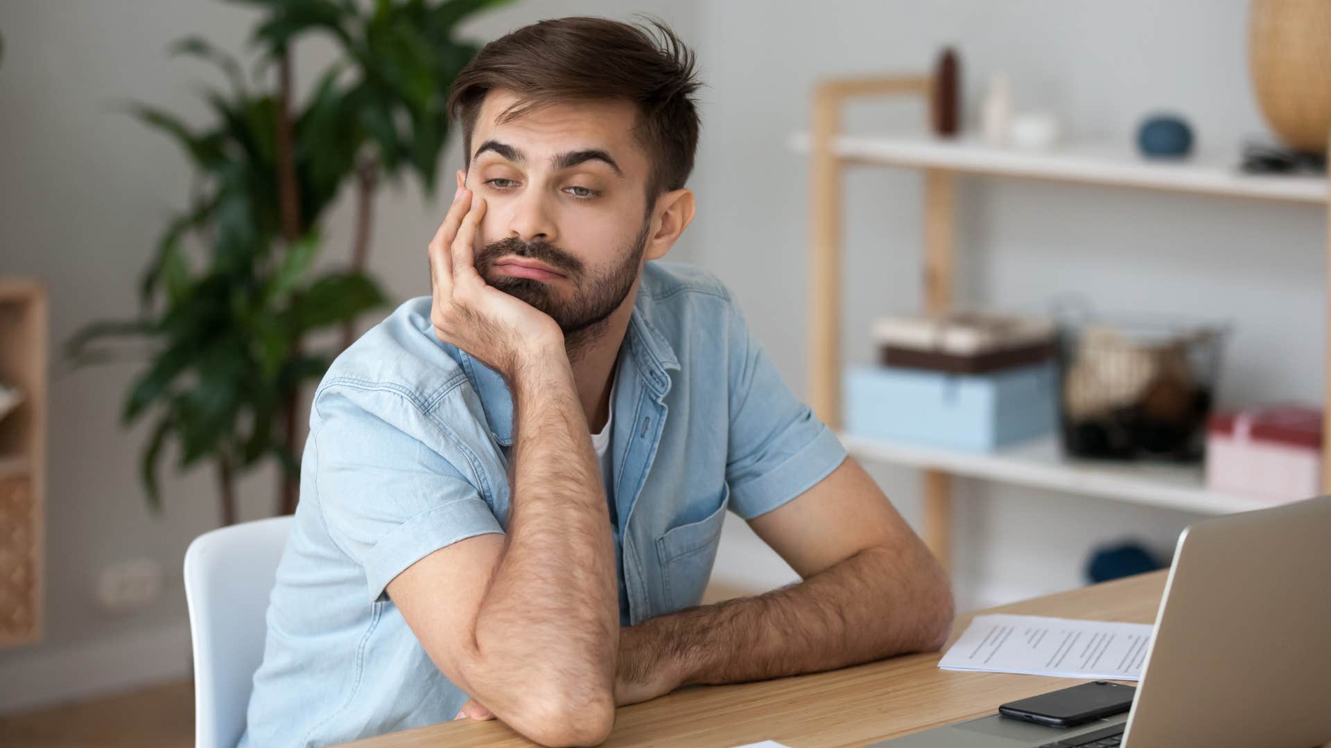 man losing interest in things he once enjoyed doing as he zones out bored