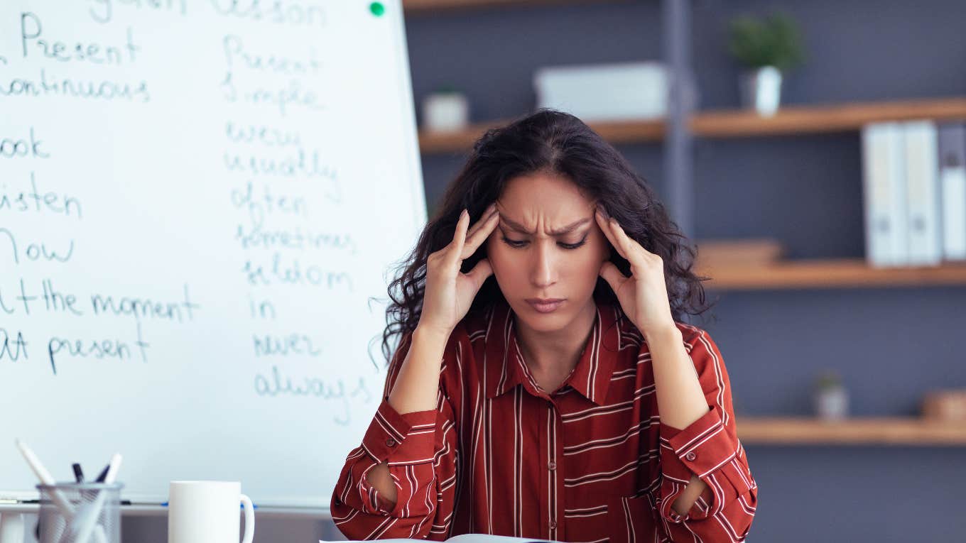 stressed teacher sitting in classroom