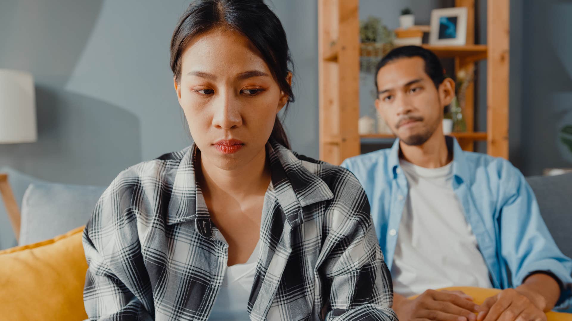 Woman turned away from her husband who's overly critical.