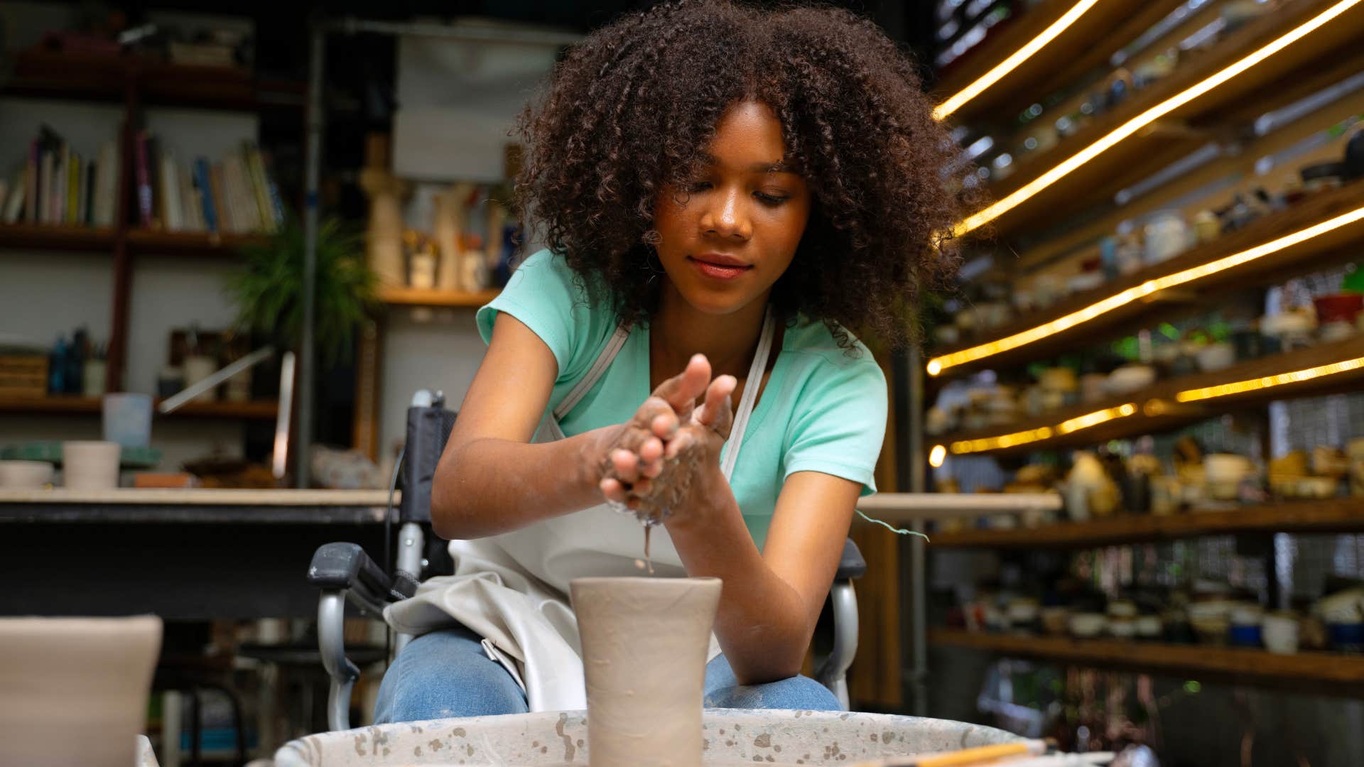 woman who believes every hobby should be a side hustle doing pottery