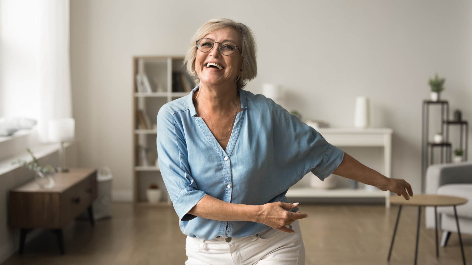 older woman smiling celebrating and dancing