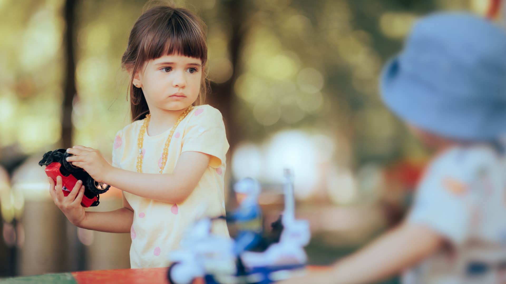 an entitled little girl does not allow another child to play with her toys