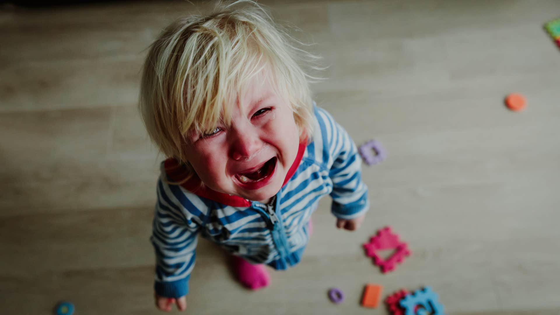 an entitled little boy yells that is mine to his mother as she picks up his toys