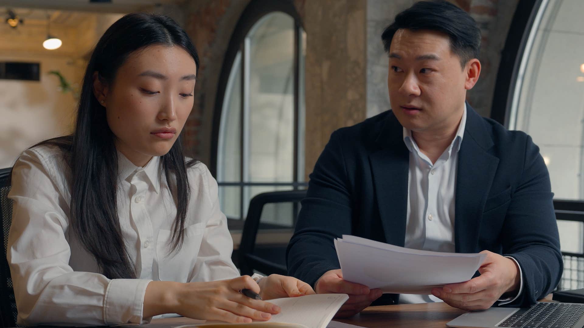 Woman not accepting feedback in a meeting with her boss.