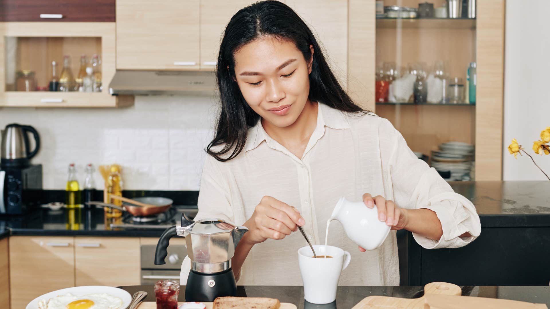 Woman making herself coffee before leaving the house