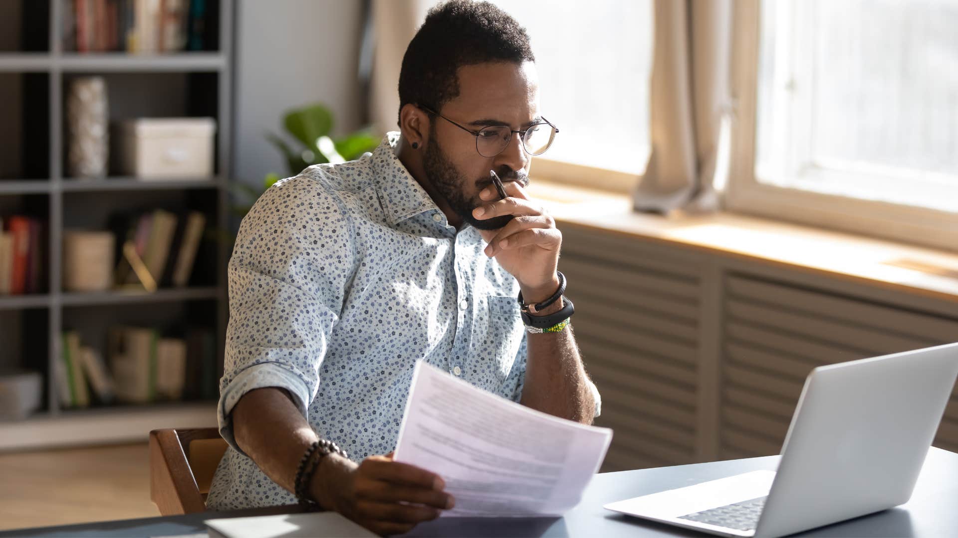 Man reviewing his upcoming bills before leaving the house