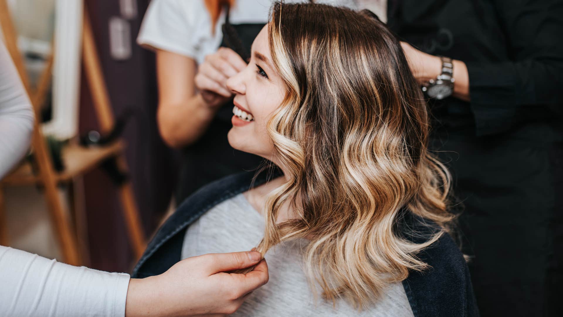 Woman getting haircuts in a salon.