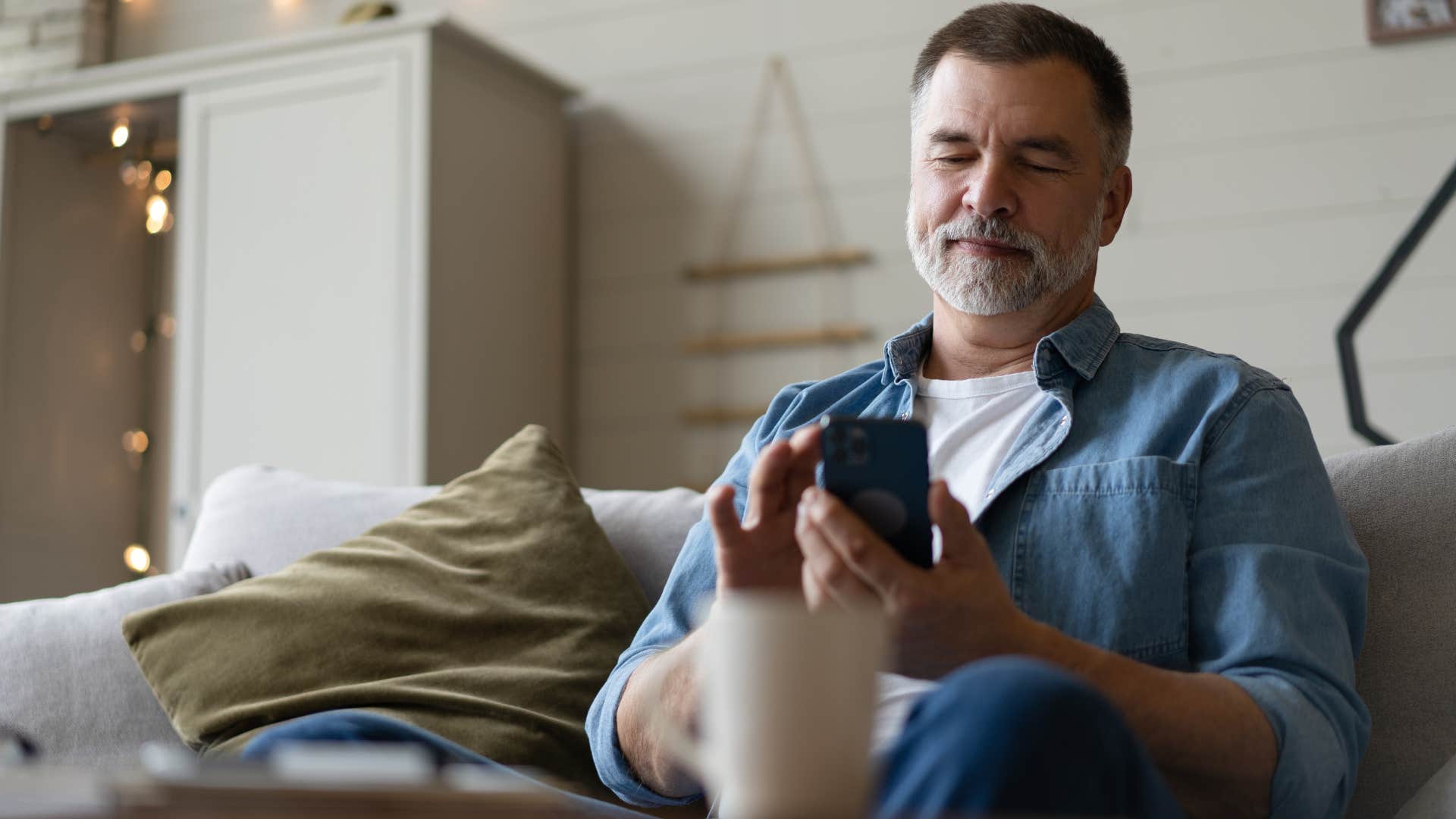 Man looking at his utility bills on his phone.