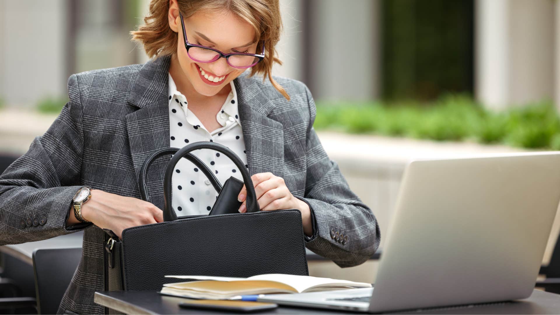 woman taking journal out of her purse