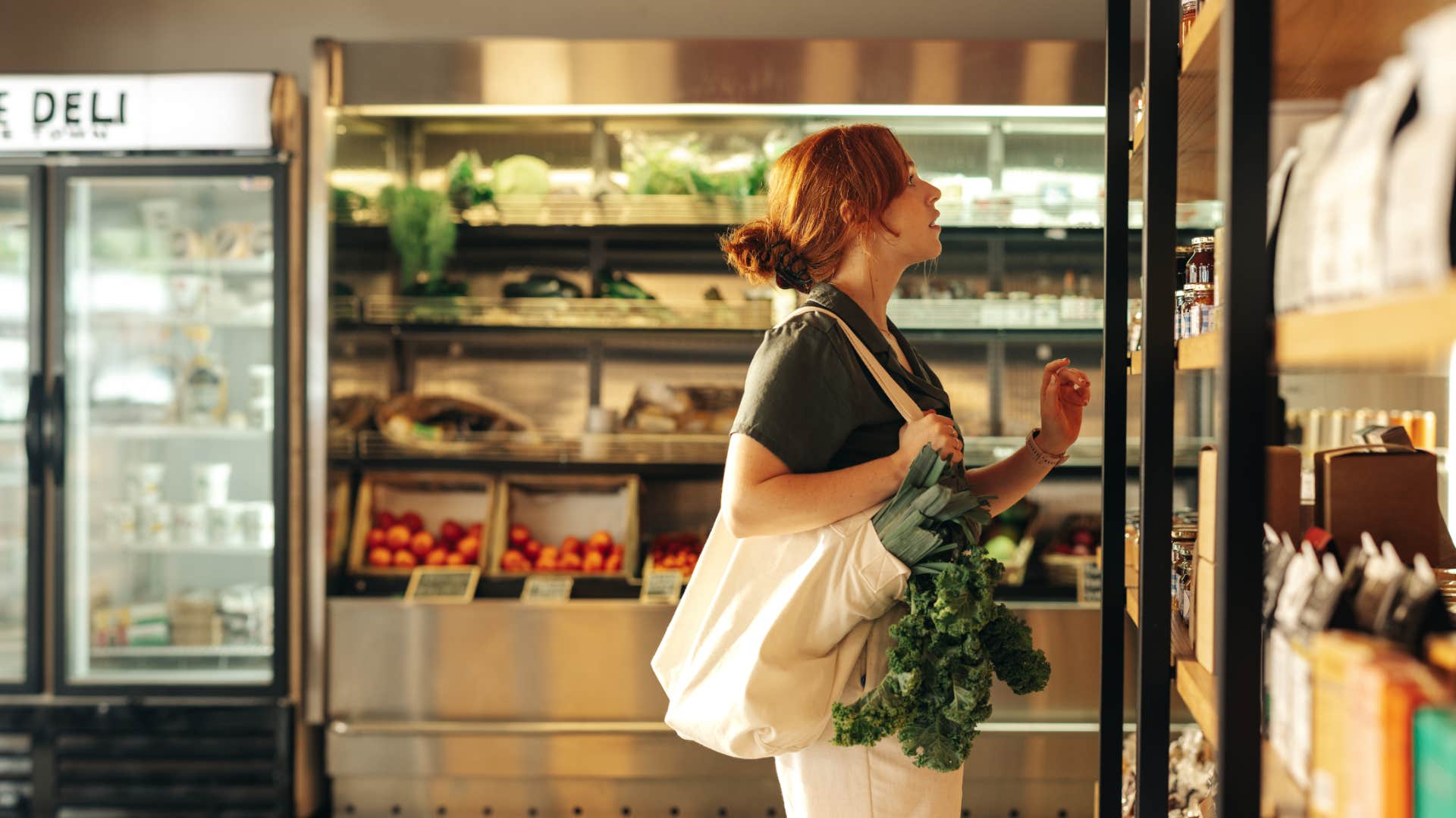 frugal woman at the grocery store using reusable bag