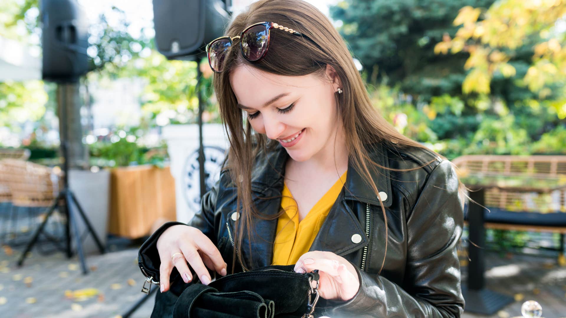 frugal woman looking in her bag for sewing kit