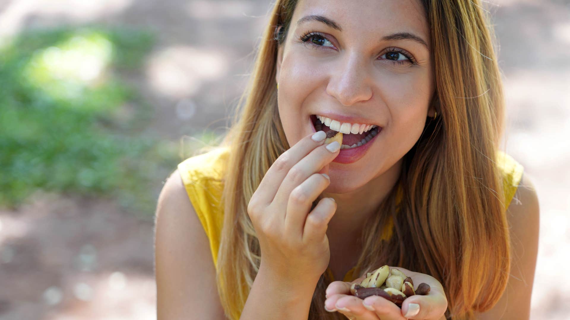 woman snacking sitting outside