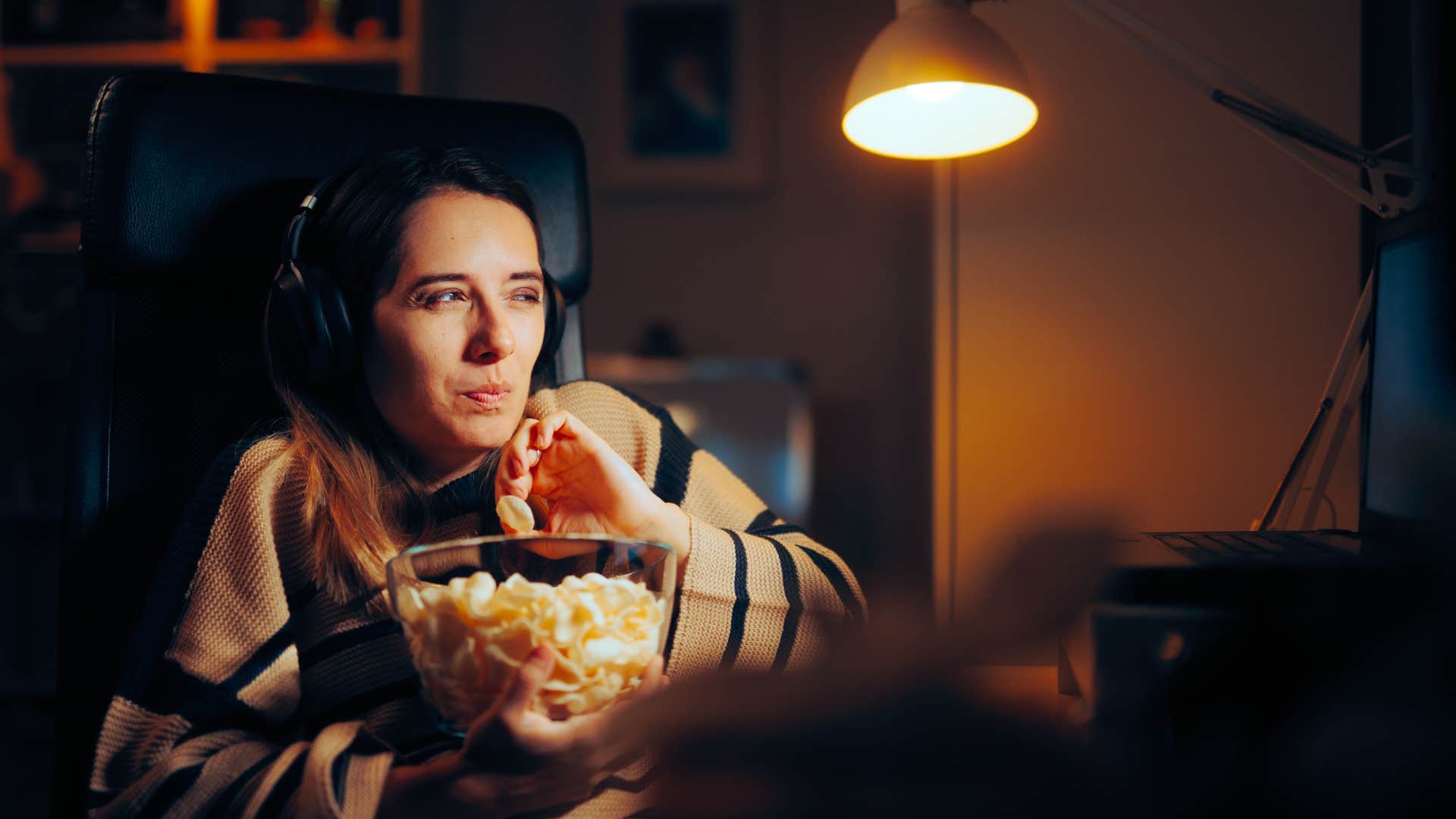 a young woman watches movies on her laptop and will never buy cable television again