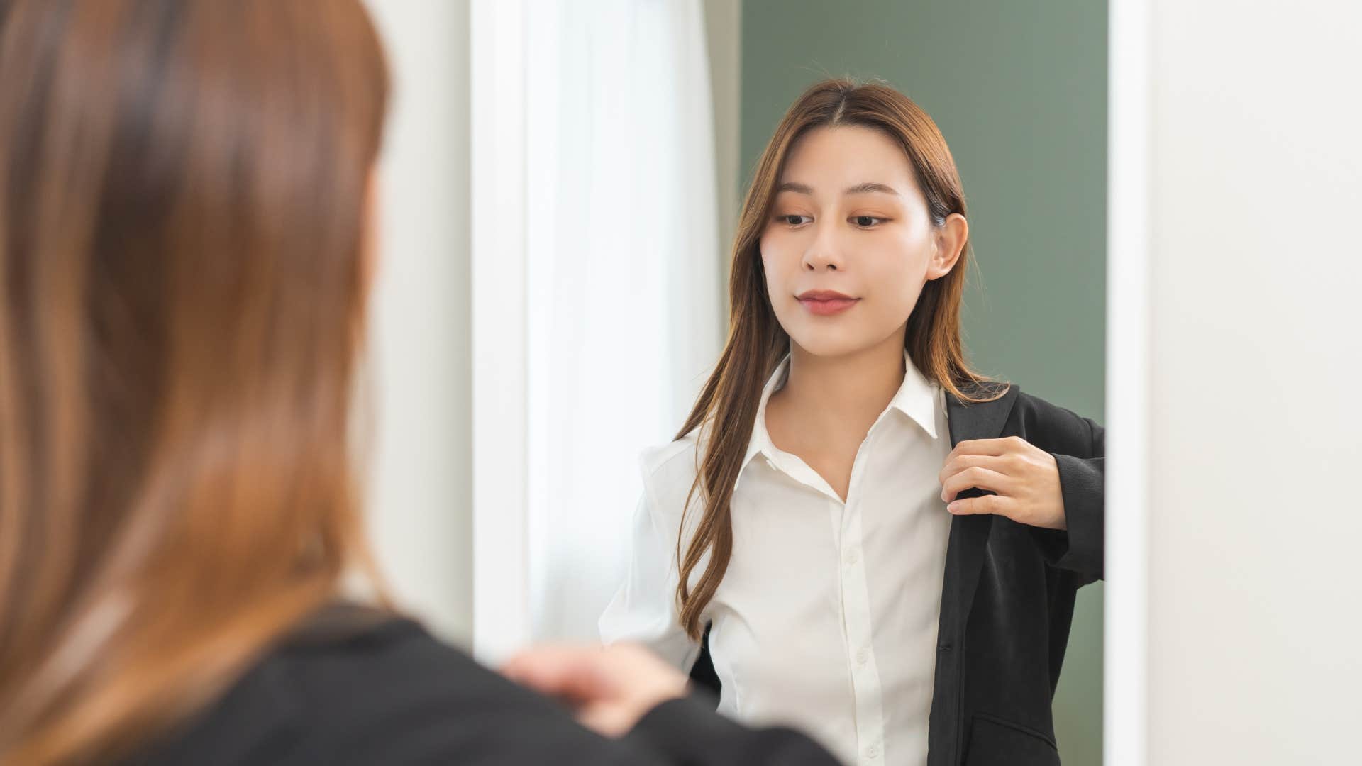 a woman dresses formally for her job even though she does not have to anymore