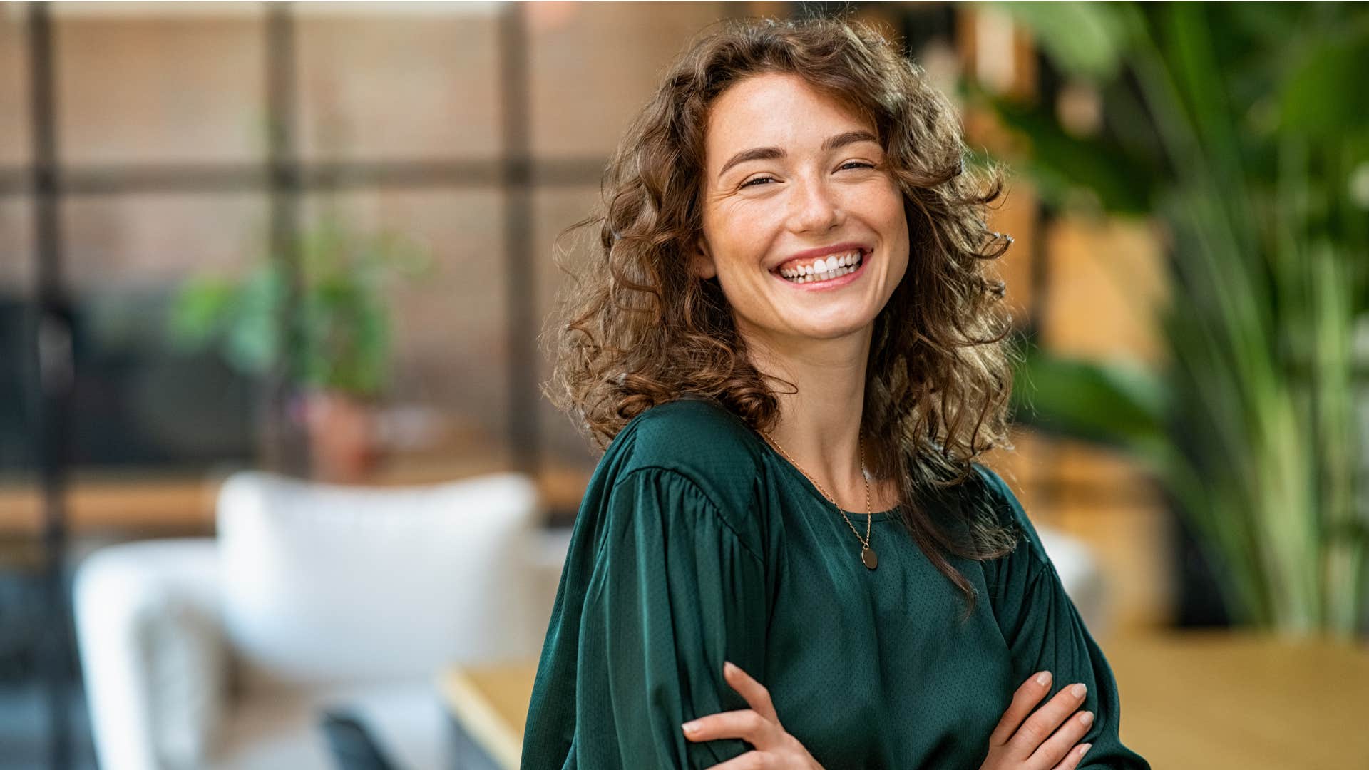 woman in green shirt prioritizing authenticity over reputation as she smiles brightly