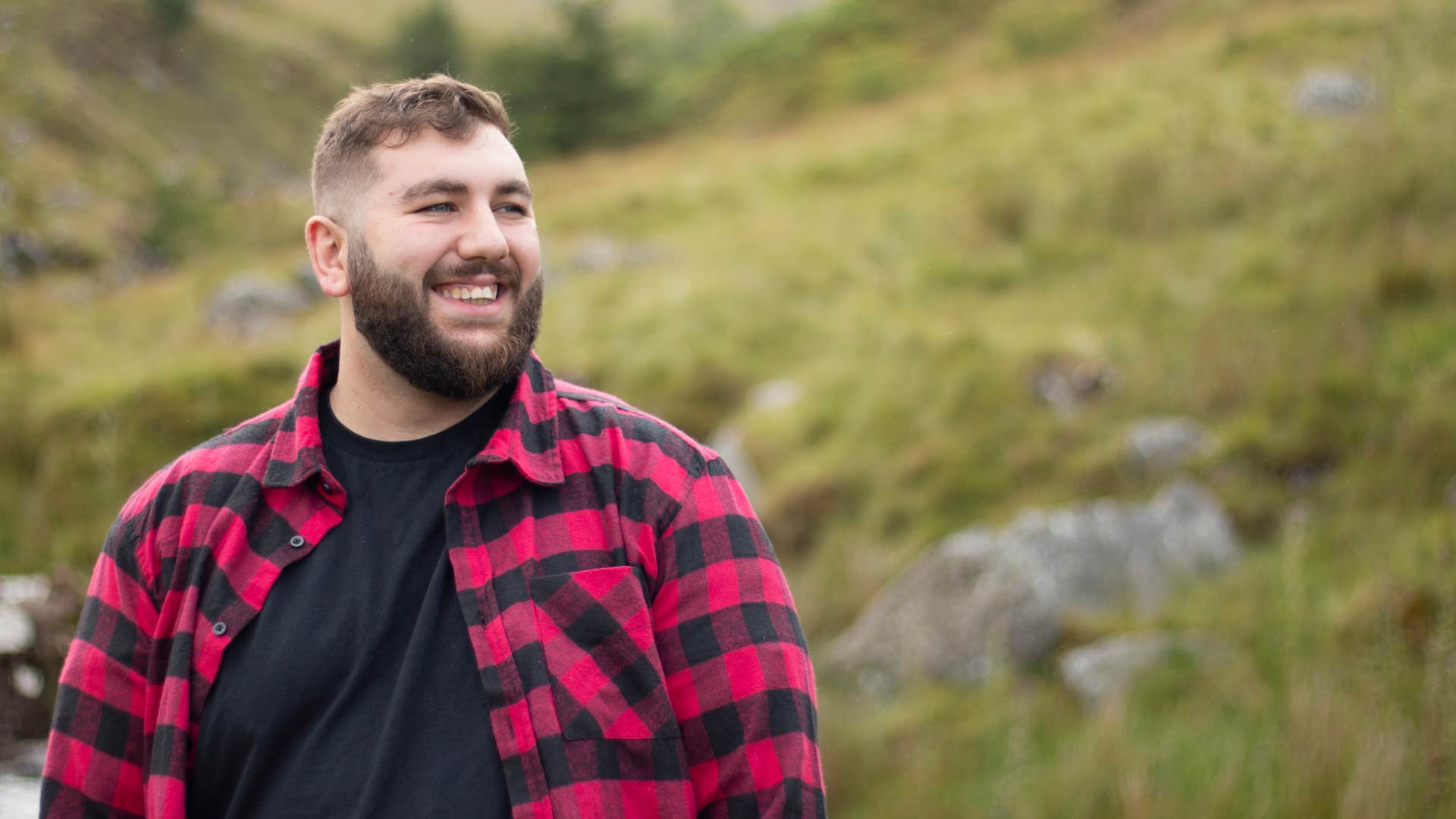 man in black shirt redefining the beauty standard as he's outside