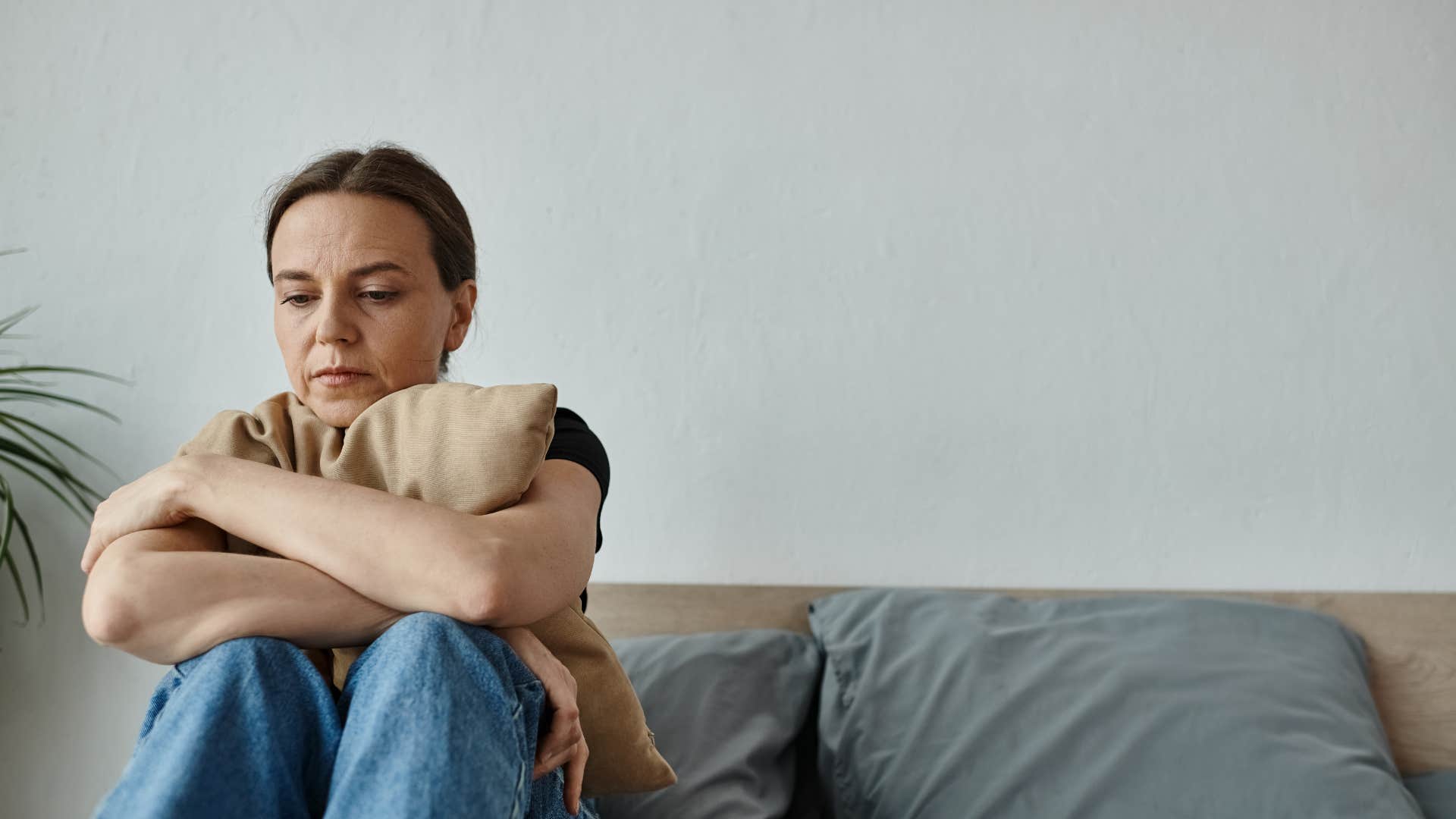 introverted woman sitting at home sad