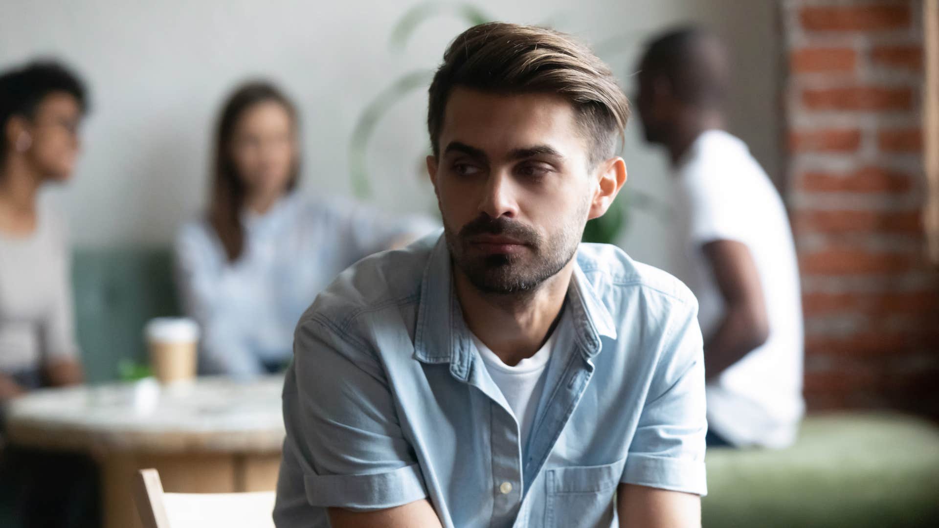introverted man staying distant from strangers